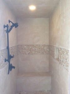During Shower with bench  New tile and fixtures and niche